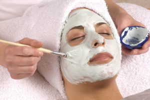 Esthetician Applies Face Cream On Client