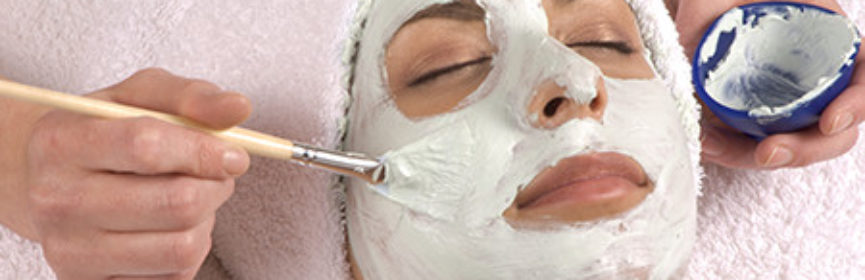 Esthetician Applies Face Cream On Client